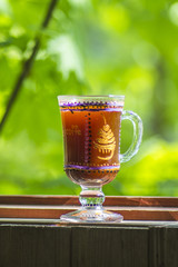 glass of Irish coffee on beautiful green natural background.
