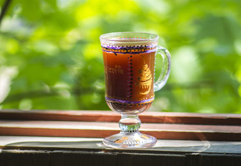 glass of Irish coffee on beautiful green natural background.