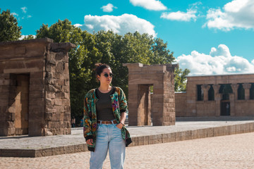 Portrait of a young spanish woman traveller student with floral pattern jacket in Madrid