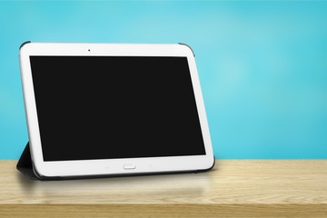 Modern digital tablet on wooden background
