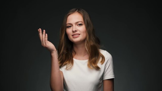 Portrait of young beautiful caucasian woman blowing a kiss and smiling.