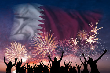 People are looking on fireworks and flag of Qatar