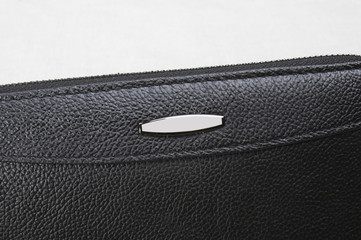 metal button on the purse close-up; closed black purse