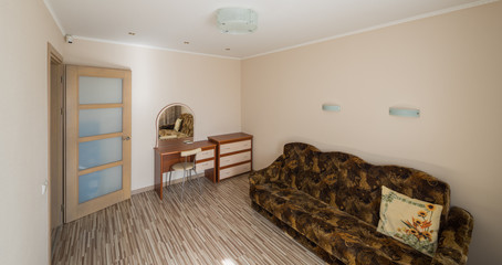 Interior of the flat. Warm tones, wooden floor. 