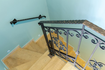 wooden staircase with iron railings.