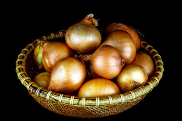 Basket of Fresh Onions on a Black Background