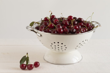 cherry in a colander on a white background