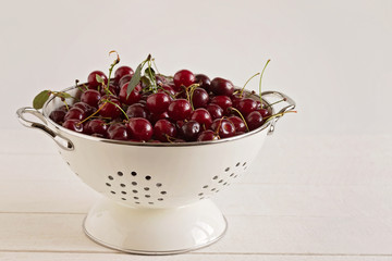 cherry in a colander on a white background