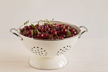cherry in a colander on a white background