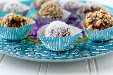 Homemade chocolate truffles each in its own foil cup.