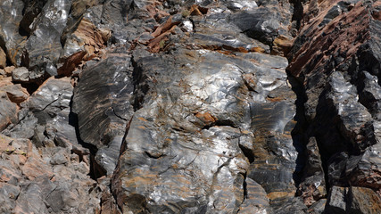 Sunlight reflects from the shiny surface of a volcanic glass rock at Obsidian Dome, hardened blocks of lava from a volcano in the eastern Sierra Nevada mountains of California