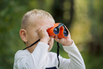 The little boy and orange binoculars