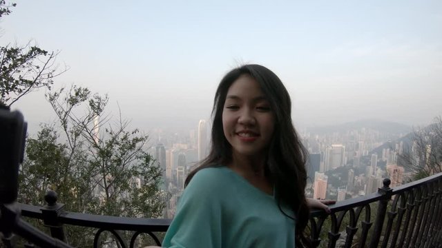 Taking selfie over Hong Kong cityscape, POV