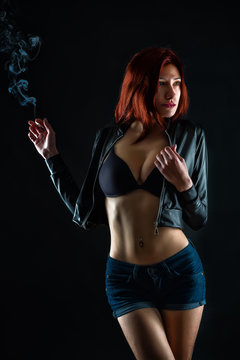 sexy girl with a cigarette on a dark background
