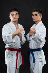 two guys karate on a dark background