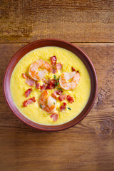 Shrimp, bacon and corn chowder. Creamy corn vegetable soup with shrimps and bacon. overhead, vertical