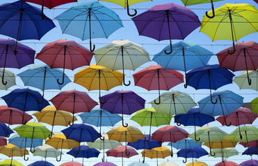 Fototapeta na wymiar Colorful umbrellas background. The sky of colorful umbrellas