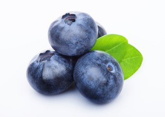 Fresh raw organic blueberries with leaf on white background. Macro close up