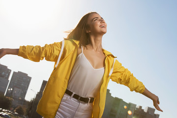 Happy woman enjoying freedom outdoor on sky background with raised hands © antgor