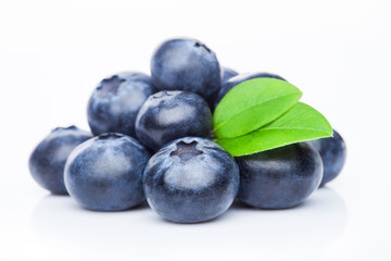 Fresh raw organic blueberries with leaf on white background. Macro close up