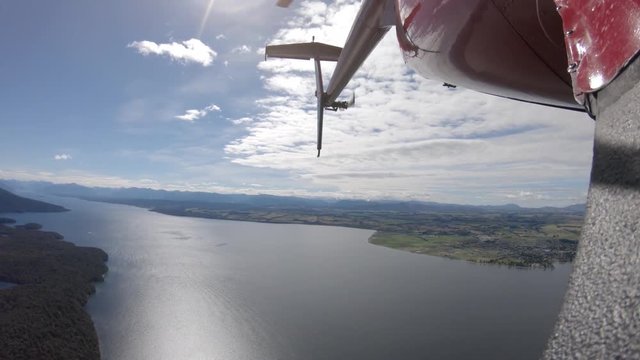 POV close up, helicopter tour over New Zealand lake