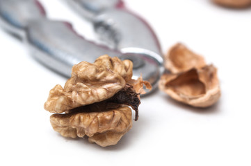 closeup of walnuts and Nutcracker.on white background