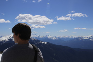 hiker looking over the top of whistler mountain in british columbia. room for copy space