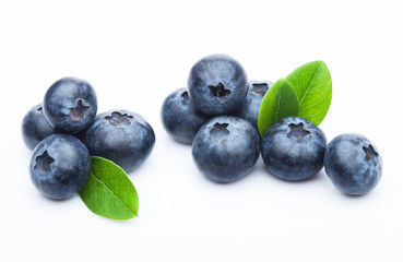 Fresh raw organic blueberries with leaf on white background. Macro close up © DenisMArt