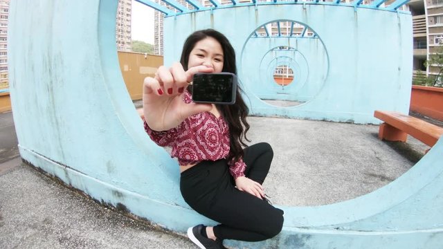 Woman takes photo of herself on Hong Kong rooftop, POV