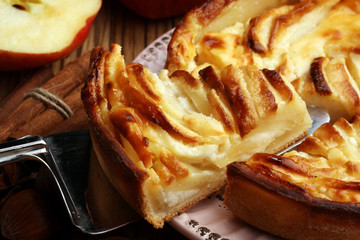 Apple tart. Gourmet traditional holiday apple pie sweet baked dessert food with cinnamon and apples on vintage background. Autumn decor. Rustic style.