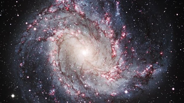 Spiral galaxy rotating in outer space Messier 83 on moving star field. Contains public domain image by NASA