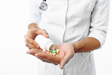 Hands close-up, in the hands of pills, on white background