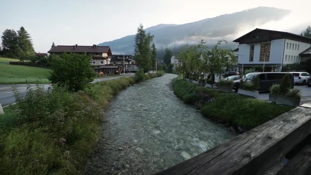 little mountain stream through village of kleinarl, austria