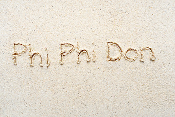 Handwriting words "Phi Phi Don" on sand