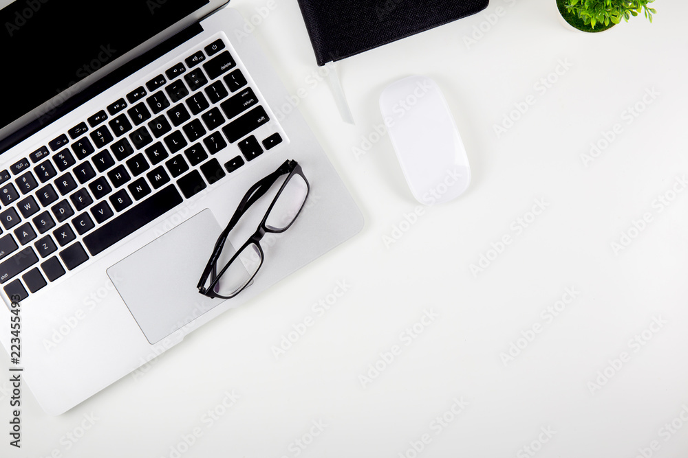 Poster top view of laptop computer, mouse and notepad and glasses isolated on white background, notebook or