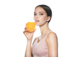 head and shoulders portrait of attractive young caucasian  woman isolated on white studio shot drinking orange juice face skin klookıng at camera