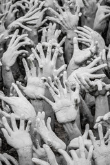 Sculpture of hundreds outreaching hands.  White Temple, Chiang Rai Thailand