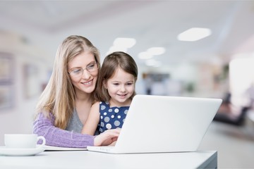 Fototapeta na wymiar Mother and daughter using laptop at home