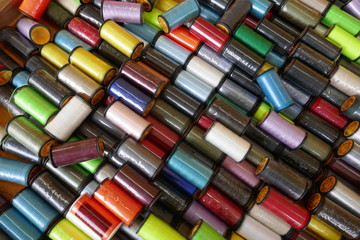 Viele bunte original verpackte  Nähgarnrollen, Nahaufnahme, Hintergrund, formatfüllend


