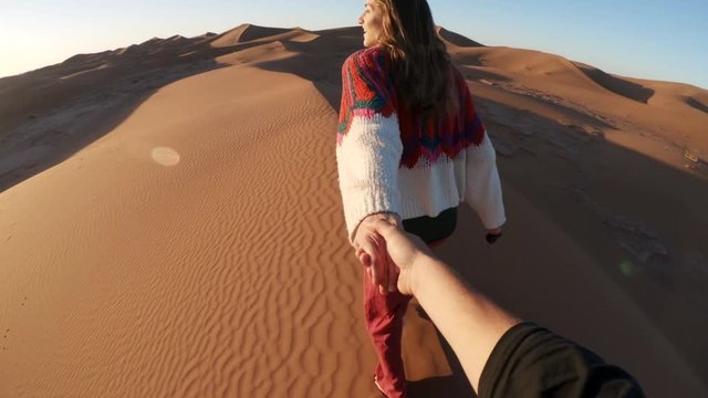 Holding hands in desert, POV