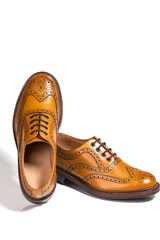 A pair of Luxury Male Full Brogued Tan Oxford Shoes. isolated Over White Background