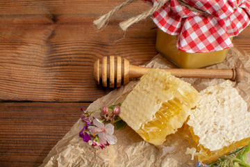 Homemade organic honey in honeycomb from farm apiary on mountains meadows with summer wild flowers