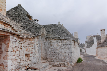 Fototapeta na wymiar Unique small South Italia city Alberobello with antient stones conical houses trullo, tourist destination