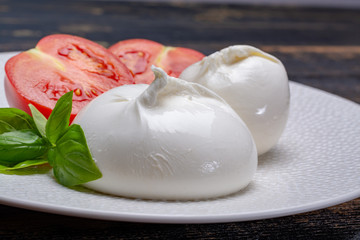 Fresh soft white burrata, ball buttery cheese, made from a mix of mozzarella and ricotta cream,...