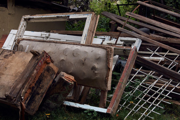 Garbage dump in the green forest, close-up. Environmental contamination concept