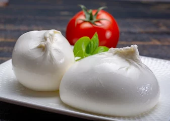 Fototapete Fresh soft white burrata, ball buttery cheese, made from a mix of mozzarella and ricotta cream, original from Apulia region, Italy, very popular soft cheese in USA © barmalini