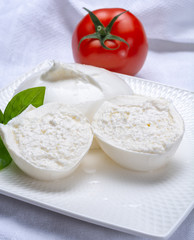 Fresh soft white burrata, ball buttery cheese, made from a mix of mozzarella and ricotta cream, original from Apulia region, Italy, very popular soft cheese in USA