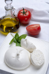 Fresh soft white burrata, ball buttery cheese, made from a mix of mozzarella and ricotta cream, original from Apulia region, Italy, very popular soft cheese in USA