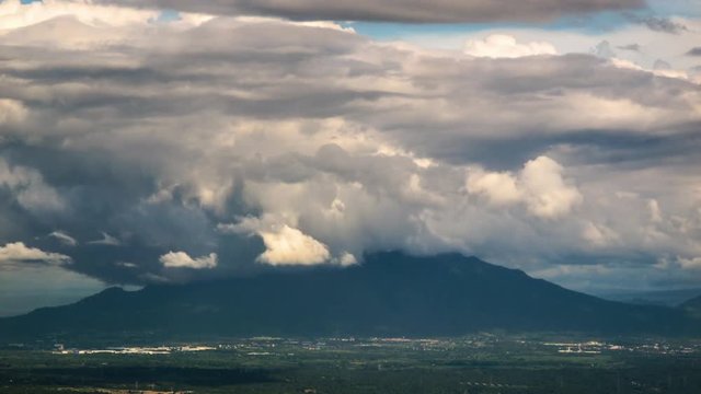 Mountain Makiling with heavy clouds surroundings. Time lapse wide shot with visible valley beneath.