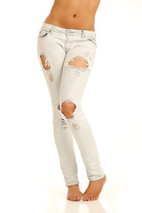 Young sexy womans torn jeans with bare waist isolated on white background